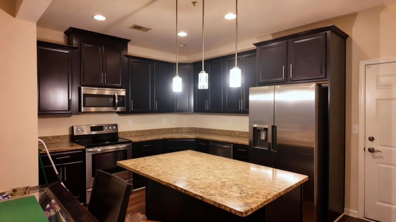 Kitchen with granite island and stainless appliances
